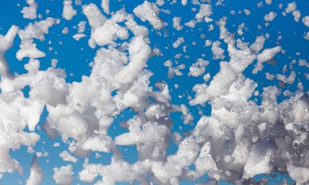 White foam against the blue sky as background .の写真素材