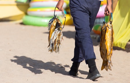 bunch of smoked fish in handの写真素材