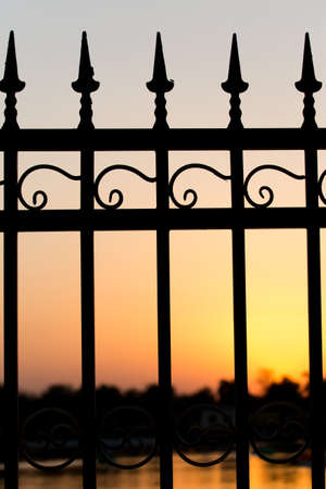 metal fence at sunsetの写真素材