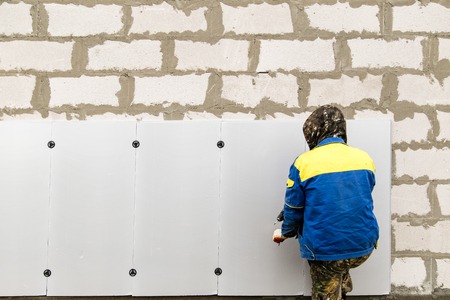 The worker insulates the house from foam plastic .の写真素材