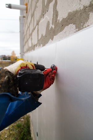 The worker insulates the house from foam plastic .の写真素材
