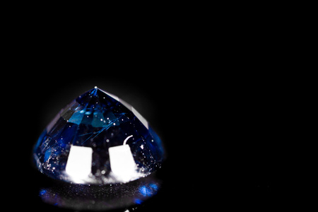 A blue gem on a black background. macroの写真素材
