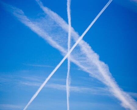 traces of an airplane on a blue sky .の写真素材