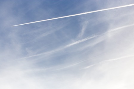 traces of an airplane on a blue sky .の写真素材