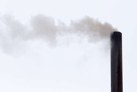 Smoke from a pipe on a cloudy skyの写真素材