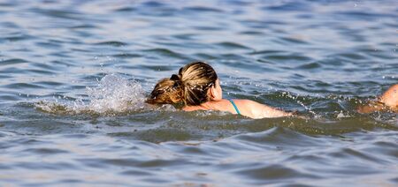 Girl swims in the lakeの写真素材