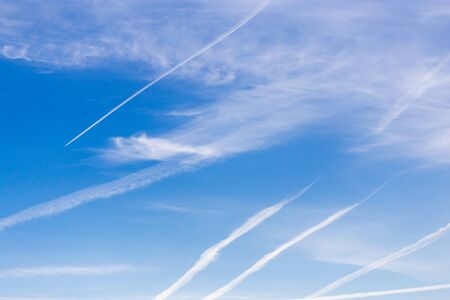 traces of an airplane on a blue sky .の写真素材