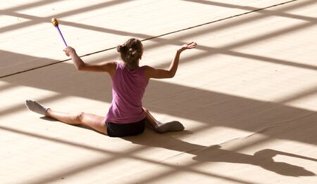 girl on a professional gymnast in the hall .の写真素材