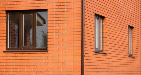 window in a red brick house as a backgroundの写真素材
