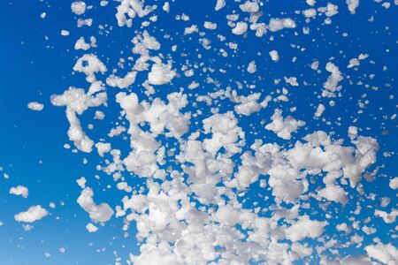 White foam against the blue sky as background .の写真素材