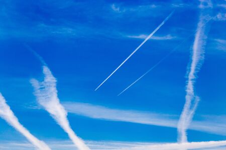 traces of an airplane on a blue sky .の写真素材