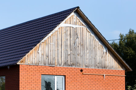 roof of a cottage house against a blue sky .のeditorial素材