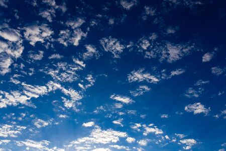 rain clouds on a blue sky as a background .