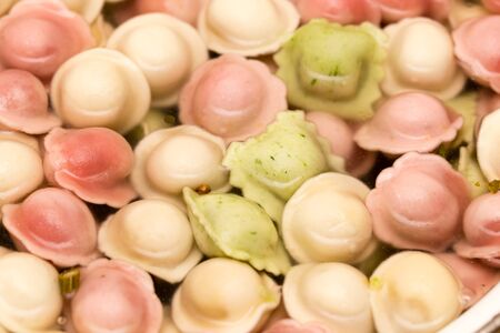 multicolored dumplings are cooked in the kitchen .の写真素材