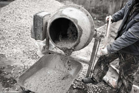 worker pours concrete mortar on a construction site .の写真素材