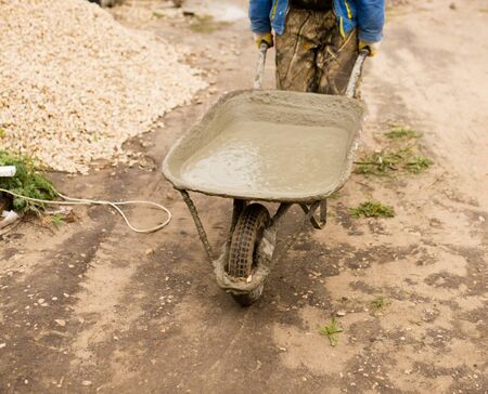 worker pours concrete mortar on a construction site .の写真素材