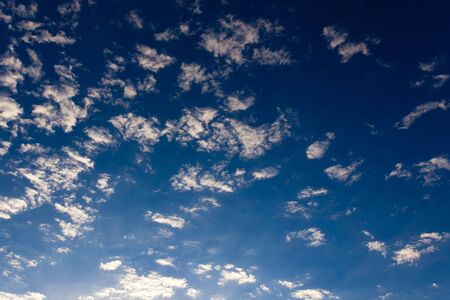 rain clouds on a blue sky as a background .