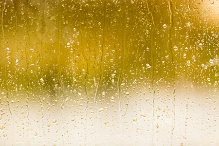 drops of rain on the window as a background .