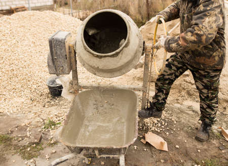 worker pours concrete mortar on a construction site .の写真素材