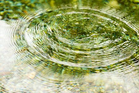 Circles on the smooth surface of the water on the river .の写真素材