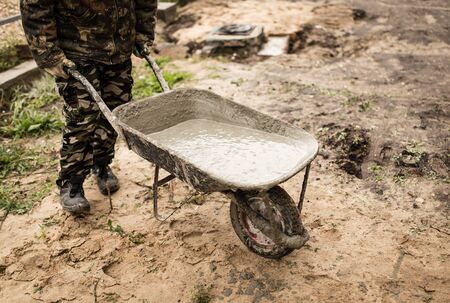 worker pours concrete mortar on a construction site .の写真素材