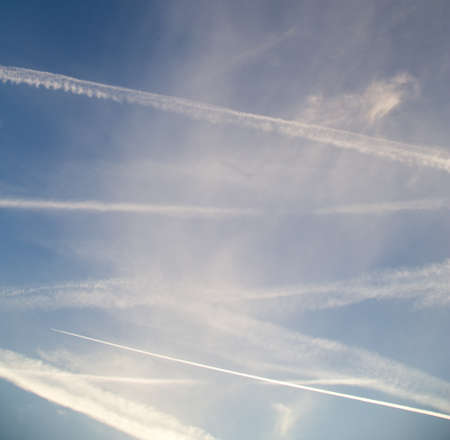 traces of an airplane at sunset as background .の写真素材