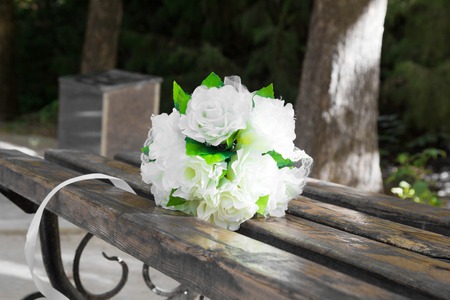 Wedding bouquet on the wooden benchの写真素材