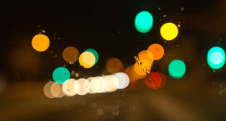 Snow with droplets on the car glass at nightの写真素材