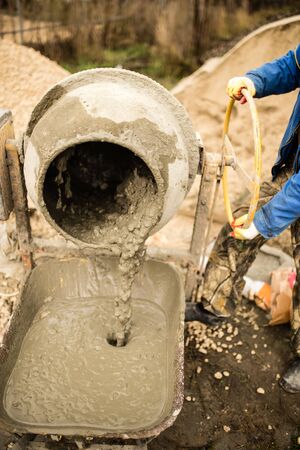 worker pours concrete mortar on a construction site .の写真素材