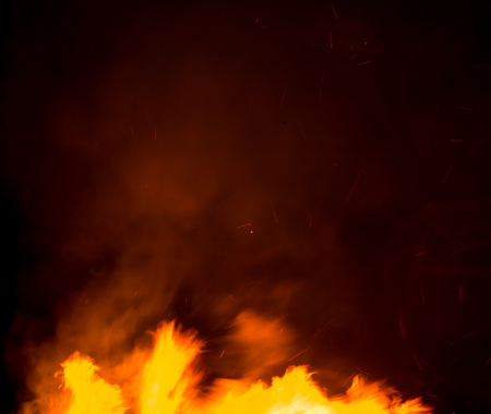 fire with smoke on a black background .