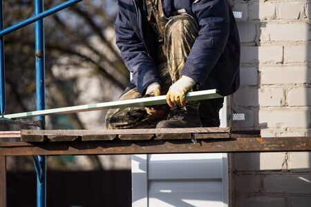 Workers walling the house with wall siding .の写真素材