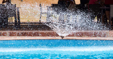 Splashes of blue water in the pool .の写真素材