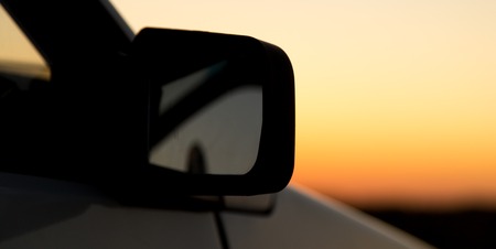 Glass from the car in the sun at dawn .