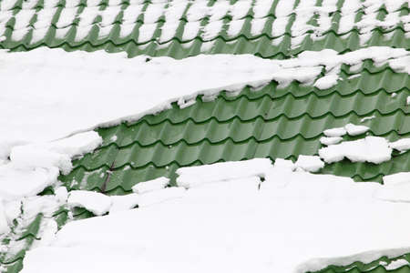 Snow on the roof of the house .の写真素材