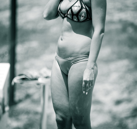 A girl in a swimsuit near the pool .の写真素材
