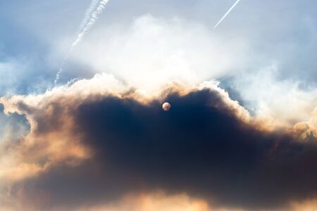 Industrial smoke closes the sun in the sky .