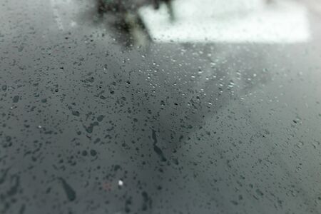 Snowflakes on a black car as a background .の写真素材