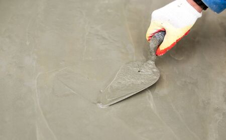 worker pours concrete mortar on a construction site .の写真素材