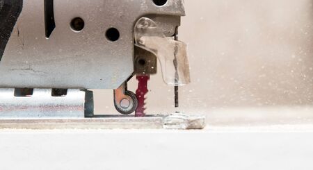 Master cuts wood with a jig saw .の写真素材