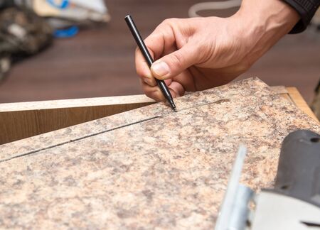 Master cuts wood with a jig saw .の写真素材