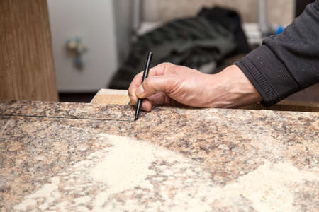 Master cuts wood with a jig saw .の写真素材