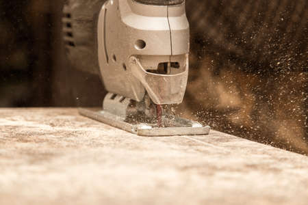 Master cuts wood with a jig saw .の写真素材