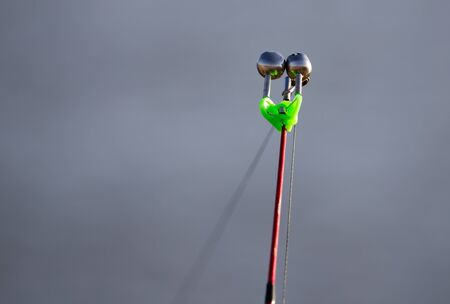 The fishing rod stands on the river bank .の写真素材