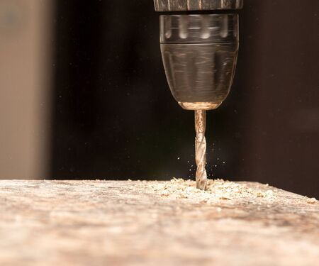 The master cuts the wood with a drill .の写真素材