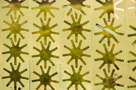 Decorative metal fence with stars as background .