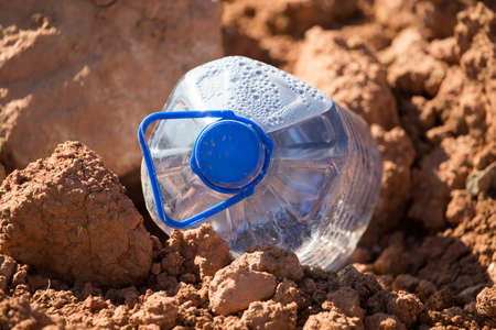 Blue plastic water bottle in the natureの写真素材