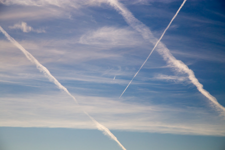 traces of an airplane at sunset as backgroundの写真素材