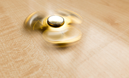 The golden spinner is spinning on the tableの写真素材
