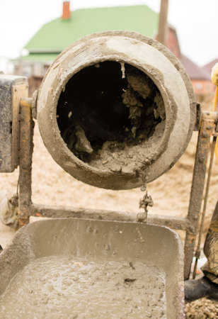 worker pours concrete mortar on a construction siteの写真素材