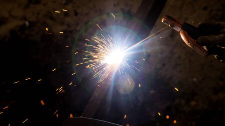 Sparks from welding at the construction site .
